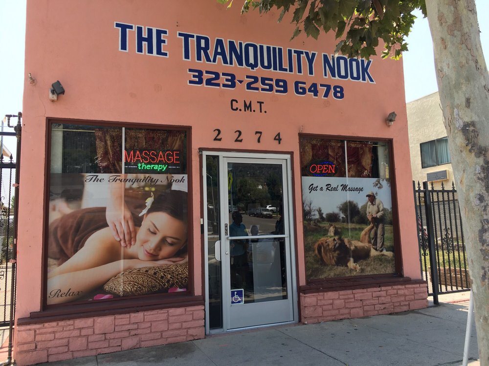 The Tranquility Nook, a small pink building on Colorado Boulevard with its name and phone number painted on the front.
